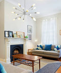 Mid Century Modern Pendant Light 6 Light Sputnik Chandelier In Black And Gold With Adjustable Arms in a stylish living room setting