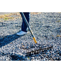 Person using Steel 16 Tine Bow Rake With 57 Inch Hardwood Handle And Cushy Grip For Small Yard Work And Landscaping Projects