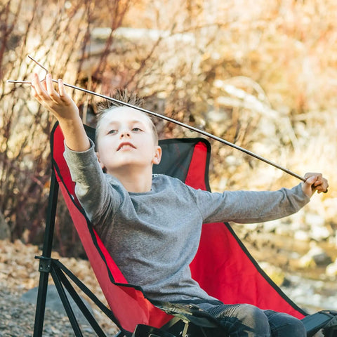 Child holding 45 Inch Extra Long Marshmallow Roasting Sticks Kit For Campfire Smores, 4 Pack Telescoping Skewers outdoors