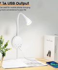 Total Game Changer Led Wall Mount Reading Lamp With Touch Panel And Five Dimmer Settings For Peak Cozy Vibes Includes Usb Charge Port Smart Night Timer And Flexible Gooseneck Design In Clean White, mounted beside books on a desk with a plant.