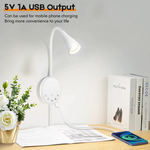 Total Game Changer Led Wall Mount Reading Lamp With Touch Panel And Five Dimmer Settings For Peak Cozy Vibes Includes Usb Charge Port Smart Night Timer And Flexible Gooseneck Design In Clean White, mounted beside books on a desk with a plant.