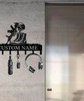 Personalized Gun Theme Wall Hooks For Keys And Clothes, Heavy Duty Matte Black Cast Iron, Engraved With Your Name displayed on wall.