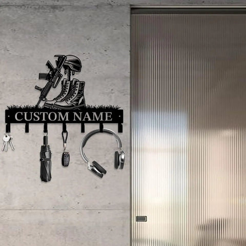 Personalized Gun Theme Wall Hooks For Keys And Clothes, Heavy Duty Matte Black Cast Iron, Engraved With Your Name displayed on wall.