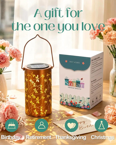 Dragonfly Solar Lantern Outdoor Decor For Patio And Garden next to a box on a table with flowers, showcasing packaging and design.
