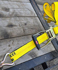 Heavy Duty 2 Inch By 27 Foot Ratchet Tie Down Straps With Wire Hooks secured on flatbed, showcasing ratchet mechanism and hook attachment.