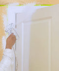 Painting a door with spray gun using Masking Paper And Tape Set For Painting Projects 4 Rolls 50 Feet Each Assorted Sizes.