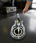 Rock Solid Heavy Duty Hydraulic Bearing Puller 20 Ton Capacity in action extracting bearing from a hub on a garage floor.