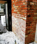 Heavy Duty Wet Look Concrete Sealant High Gloss Water Repellent Coating For Masonry Stone Slate Tile UV Resistant Water Based Formula That Slaps On Smooth And Gives Your Floors That Slick New Shine 5 Gallons applied to a brick wall in a home.