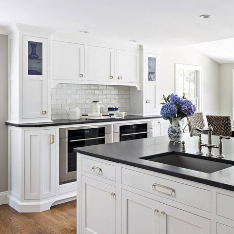 Modern white kitchen with Champagne Bronze Cabinet Pulls With Center Hole 5 Inch Length Modern Zinc Finger Handles on cabinets.