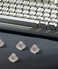 Top Shelf 10 Pack Mechanical Keyboard Switch Actuators With Linear Three Legged Stem on desk with mechanical keyboard.