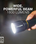 Hand holding Vision HD Ultra LED Flashlight With Digital Focus, 1800 Lumens, IPX4 Water Resistant, emitting bright beam