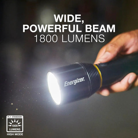 Hand holding Vision HD Ultra LED Flashlight With Digital Focus, 1800 Lumens, IPX4 Water Resistant, emitting bright beam