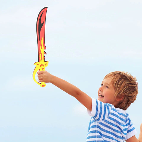 A child playing with a flame-designed foam sword from the Foam Sword And Shield Set For Kids 12 Piece Ninja Warrior Viking Role Play Gear.