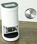 Commercial Automatic Coffee Tamper For Bustling Cafes Featuring Adjustable Pressure Dial, white body and 58mm steel head.