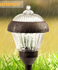 4 Pack High Lumen Metal Solar Pathway Lights With 2 Bright LED Per Light IP65 Waterproof on wet grass background