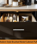 Open drawer with a modern style brushed nickel cabinet pull, beauty products inside, and a wooden countertop.