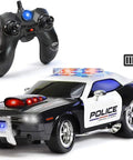 Rechargeable Police RC Car For Kids With Lights And Siren, 2.4GHz Remote Control Toy next to controller, non slip wheels