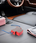 Heavy Duty Automatic Car Fire Extinguisher With Sticky Self Adhesive Patch For Quick Dash Install and Fast Engine Bay Fire Knockout in Rvs Trailers or Daily Driver Trucks on black car seat.