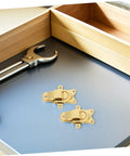 Stylish Vintage Zinc Alloy Duckbill Toggle Latch Set With All Mounting Hardware For Upgrading Wooden Jewelry Boxes And Cabinets In Super Cool Golden Finish You Will Love on a gray surface with tools.