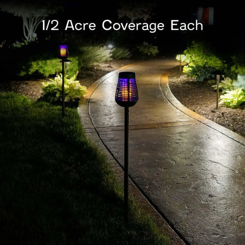 Solar Insect Killer Torch Bug Zapper And Accent Light For Patio Outdoor Pest Control That Kills Bugs On Contact With Flickering Flame LED Eco Friendly Design illuminating a garden path at night.