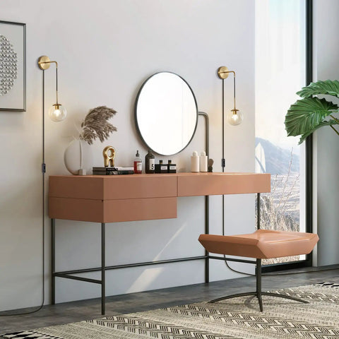 Plug In Wall Sconce Set Of 2 Modern Glass Globe Lights With Brushed Brass Finish next to a vanity mirror in a bedroom setting