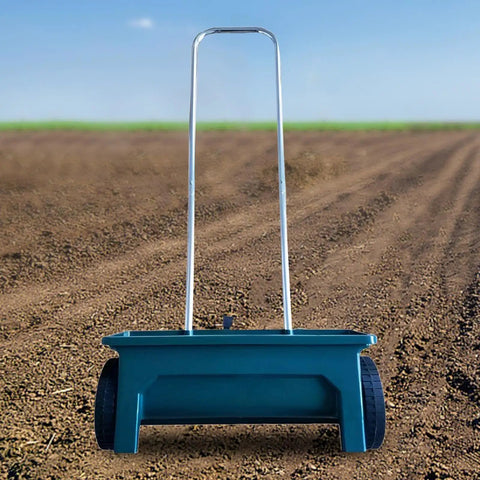 Walk Behind Seed Spreader 12 Liter Hand Push Garden Seeder Broadcast And Drop Spreader with long handle on dirt path