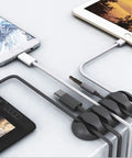 Self adhesive cable clips on desk organizing tablet and phone wires, part of 24 Pack Self Adhesive Cable Clips For Desk And Home Office Car Keep Cables Neat And Tidy Cord Organizer Wire Keeper For Chargers Computers And Other Cords.