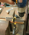 Drill in use with Pro Grade DIY-Friendly Portable Drill Guide For Straight Holes With 17 Drill Sizes on workbench