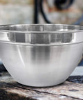 V Shaped 5 Qt Stainless Steel Mixing Bowl With Polished Finish Perfect For Baking Muffins Mixing Sauces And Melting Chocolate On A Double Boiler Durable Go To Kitchen Must Have For Home Cooks And Pros on rustic table