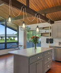 Three Light Plug In Pendant Fixture Built Different Hemp Rope Wire Hanging Lamp Fly Setup For Kitchen Island Living Room Decor Lowkey Modern Vibe Safe UL Certified Sockets Long Reach Cord above kitchen island with floral arrangement.