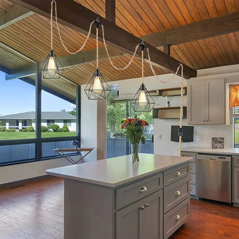 Three Light Plug In Pendant Fixture Built Different Hemp Rope Wire Hanging Lamp Fly Setup For Kitchen Island Living Room Decor Lowkey Modern Vibe Safe UL Certified Sockets Long Reach Cord above kitchen island with floral arrangement.