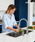 Woman using Two Hole Kitchen Faucet With Pull Down Sprayer In Brushed Nickel Finish Stainless Steel Body Side Single Handle 1.8 GPM.