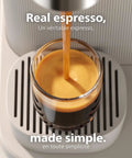 Compact Home Espresso Machine With Built In Grinder And 16 Bar Pump auto grinding tamping brewing smooth espresso pouring into glass.