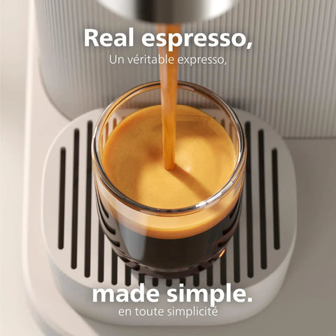 Compact Home Espresso Machine With Built In Grinder And 16 Bar Pump auto grinding tamping brewing smooth espresso pouring into glass.