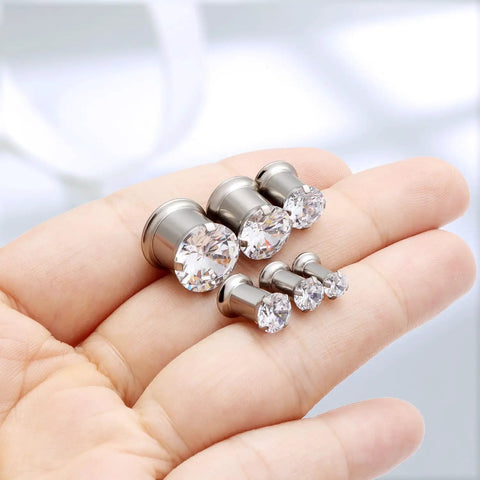 Hand holding ASTM F136 Titanium 0G Round CZ Ear Gauges Tunnels Screw Fit Flesh Plugs Gauges 8mm for body piercing jewelry.