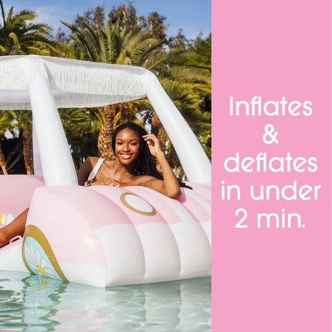 Oversized Inflatable Golf Cart Pool Float With Removable Fringe Canopy And Retro Styling in a pool with a person relaxing.