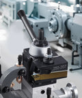 Installed quick-change tool post set with turning tool holder on metal lathe.