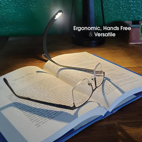 Rechargeable Clip On Book Light With Warm Eye Care LEDs, Flexible Gooseneck illuminating open book and glasses for reading in bed.