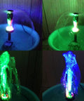 15W Submersible Fountain Pump With 12 RGB LED Lights for a lit glow, shown with mushroom and blossom fountain heads in dark setting