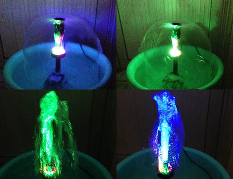 15W Submersible Fountain Pump With 12 RGB LED Lights for a lit glow, shown with mushroom and blossom fountain heads in dark setting