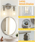 Sleek Two Light Brushed Nickel Vanity Light Fixture Over Mirror With Clear Glass Shades shown in bathroom setting