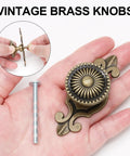 8 Piece Vintage Cabinet Knobs Set In Solid Antique Brass With Backplates shown in hand with detailed view