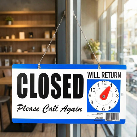 Double-Sided Closed Sign With Clock And Will Return Indicator hanging in a cafe window