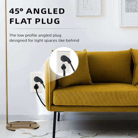 45° angled flat plug of 25 Ft Indoor Flat Plug Extension Cord With Low Profile 3 Prong Grounded Power Cable Black behind sofa