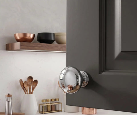 A close-up of a cabinet with a Ten Pack Polished Chrome Round Mushroom Cabinet Knobs One And One Quarter Inch Diameter With Screws Included.