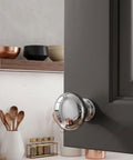 Polished Chrome Round Mushroom Cabinet Knobs Set, 25 Pack, 1-1/4 Inch Diameter shown on grey cabinet door
