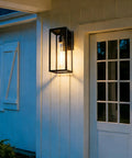 2 Pack 15 Inch Outdoor Wall Sconces With Clear Glass No Fuss Black Finish Weather Resistant Exterior Lanterns For House Garage Doorway Patio Yard With E26 Socket mounted beside a white door.