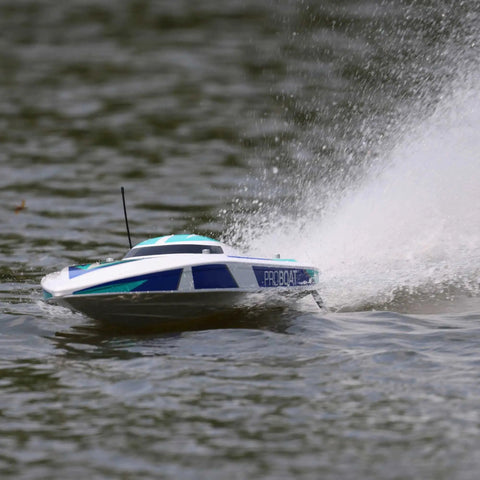 Sonicwake V2 36 Inch Self Righting Brushless RC Boat With Deep V Hull speeding on water, white color, showing splash.