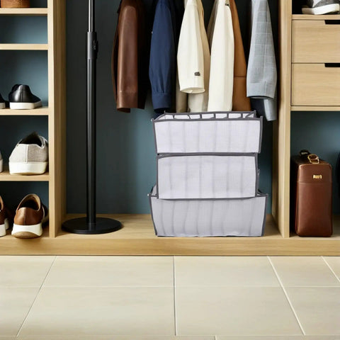 Total Closet Game Changer 3 Pack Seven Grid Foldable Bins With Grippy Handles organizing socks and pants in a closet.