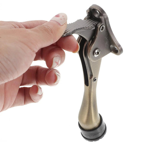 Close-up of foot-operated Kickdown Door Stopper For Commercial And Garage Doors Dope Heavy-Duty Zinc Alloy Build Coffee Color Finish